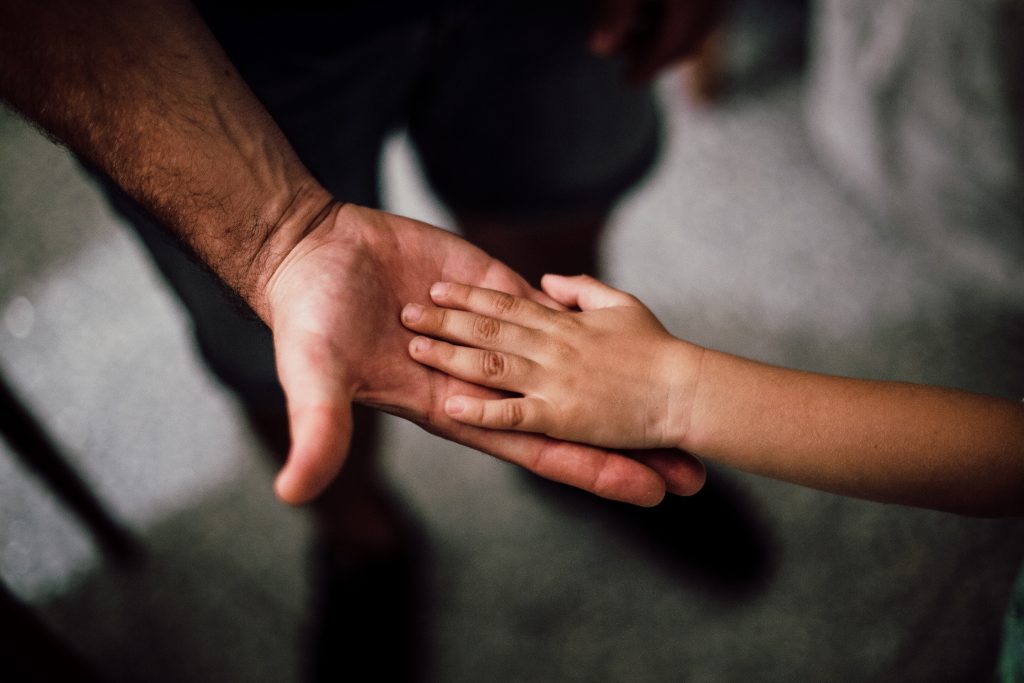 Childs hand in fathers hand