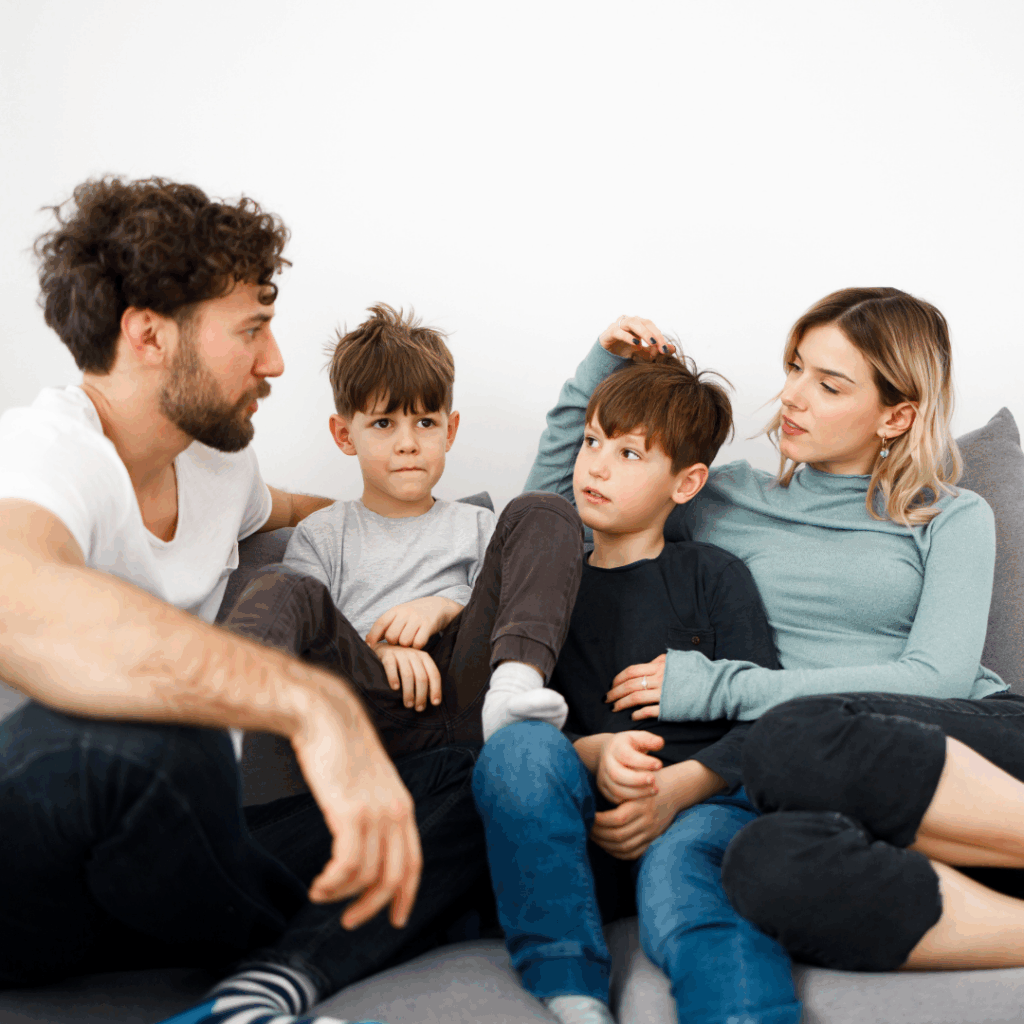 Parents and children sitting on couch talking